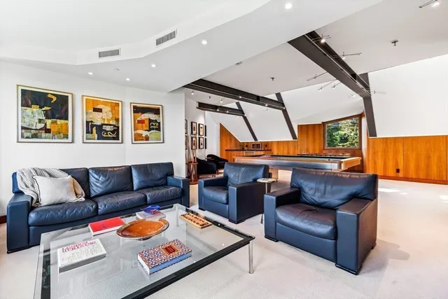 a living room with furniture a large window and a flat screen tv