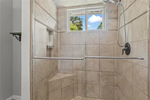 a bathroom with a window and mirror