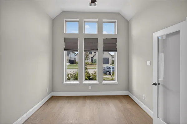a view of a room with wooden floor chandelier