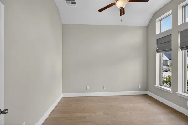 a view of a livingroom and dining room with furniture wooden floor and a chandelier