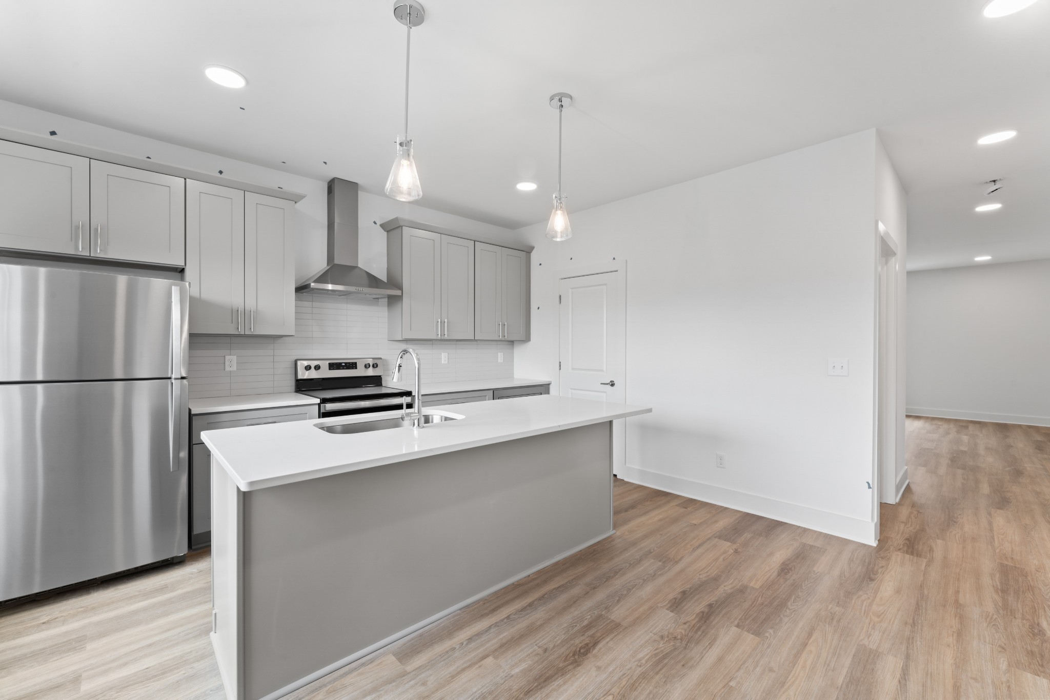 708 North Dupont Avenue Madison, TN 37115 - Photo 7 of 28 a kitchen with a refrigerator a sink and white cabinets
