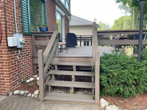 9552 Wayne Road Livonia, MI 48150 - Photo 21 of 31 Convenient side stairway provides easy access to the elevated deck, surrounded by mature landscaping.