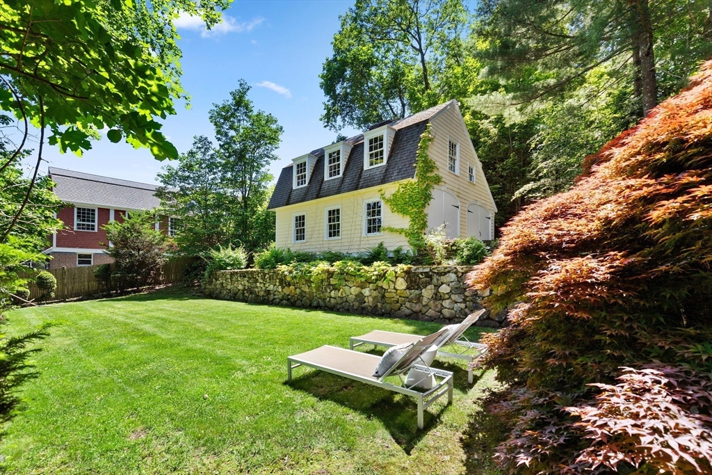 10 Eliot Road Lexington, MA 02421 - Photo 33 of 40 a front view of a house with a garden