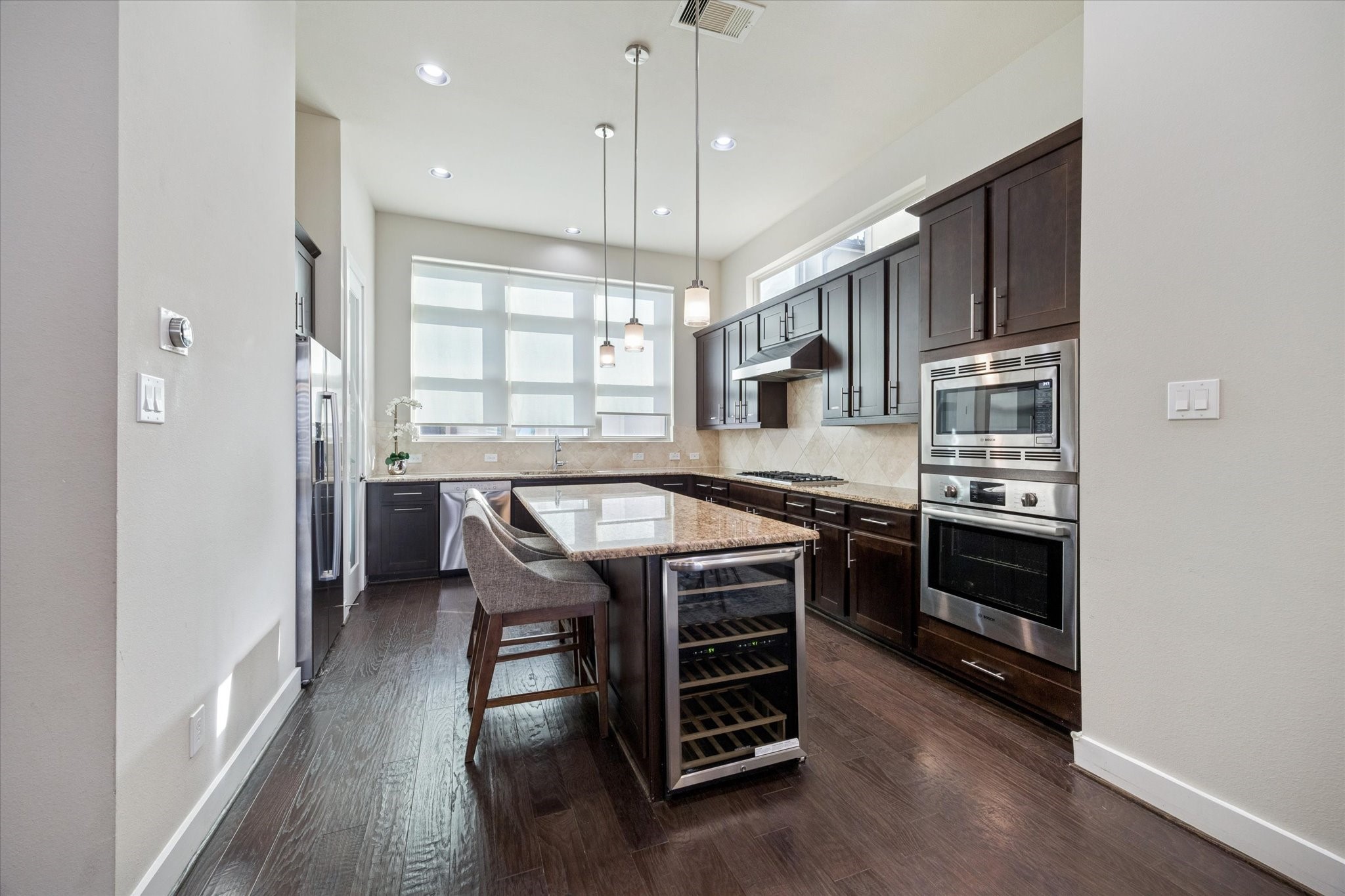 4417 Eli Street Houston, TX 77007 - Photo 7 of 24 Bosch appliance package with large island featuring a wine fridge.
