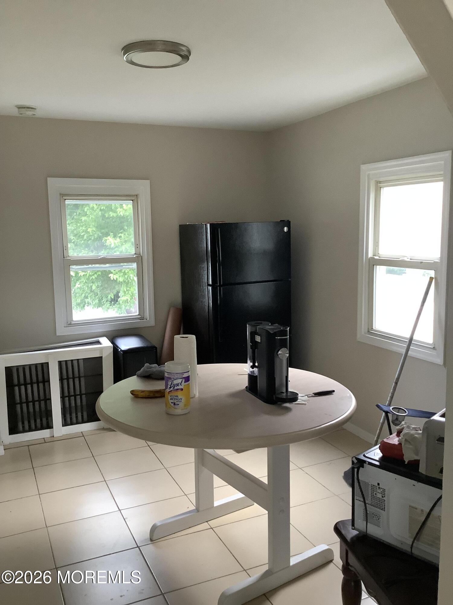 242 1st Street Keyport, NJ 07735 - Photo 11 of 23 a work room with furniture a flat screen tv and a window