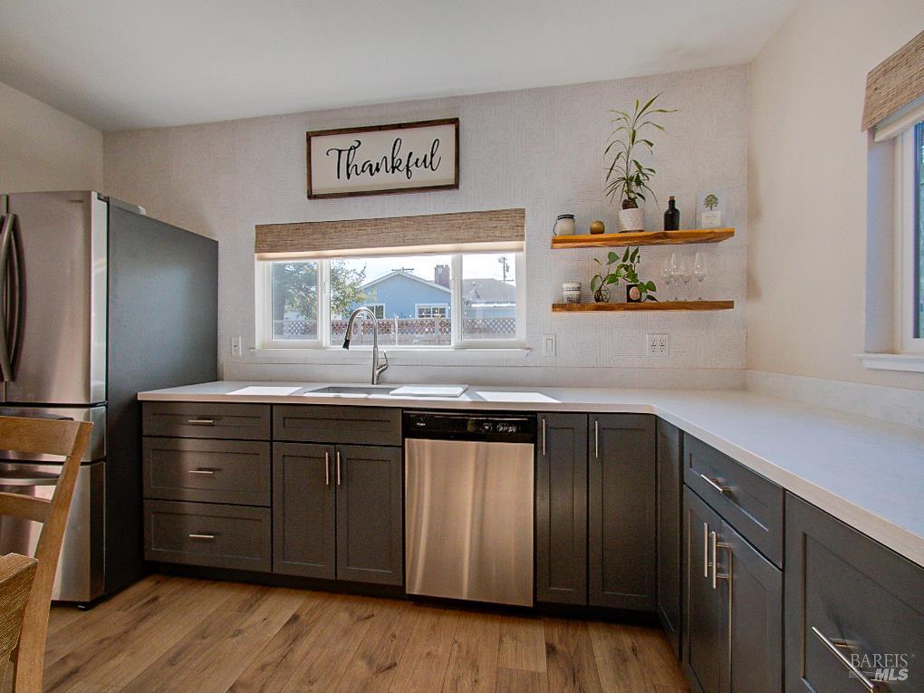 1002 Cedar Street Fort Bragg, CA 95437 - Photo 11 of 26 a kitchen with stainless steel appliances granite countertop a refrigerator and a sink