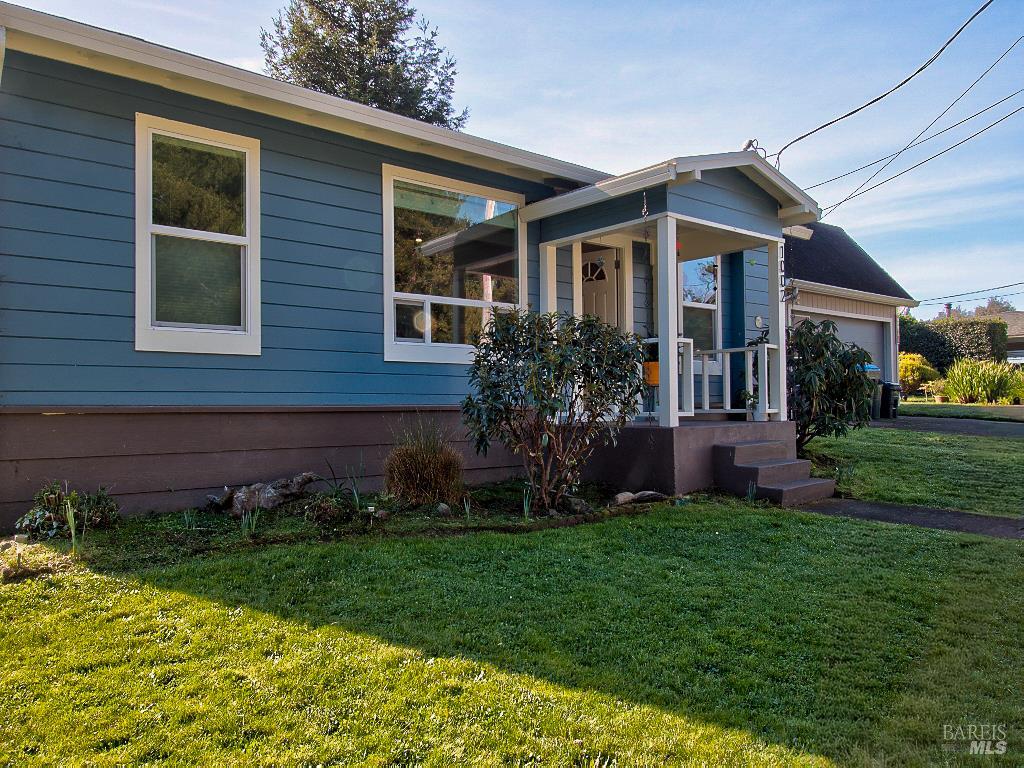 1002 Cedar Street Fort Bragg, CA 95437 - Photo 2 of 26 a front view of a house with a garden and plants