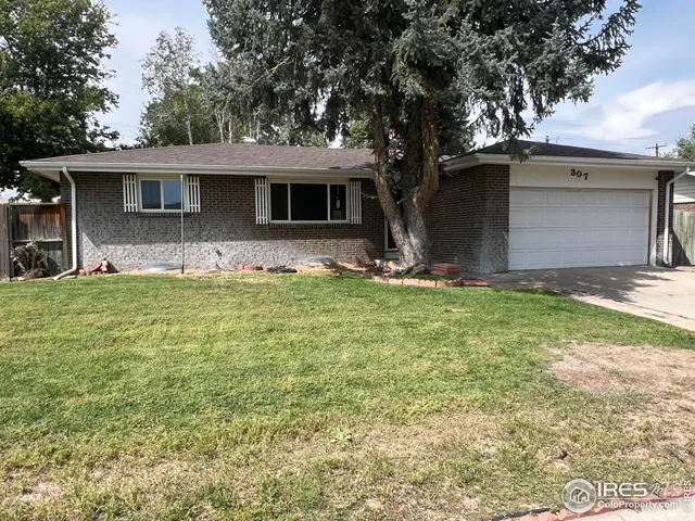 a front view of house with yard and trees