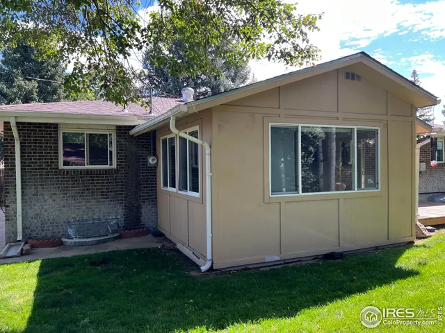 a view of house with backyard