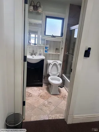 a bathroom with a sink a toilet and a mirror