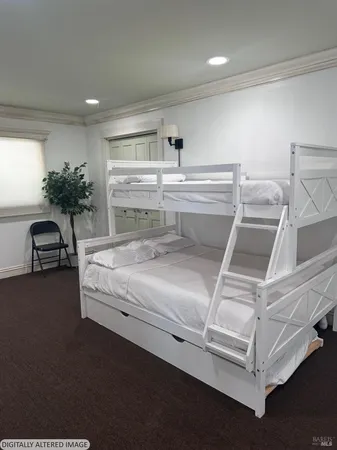 a bedroom with a bed and a potted plant