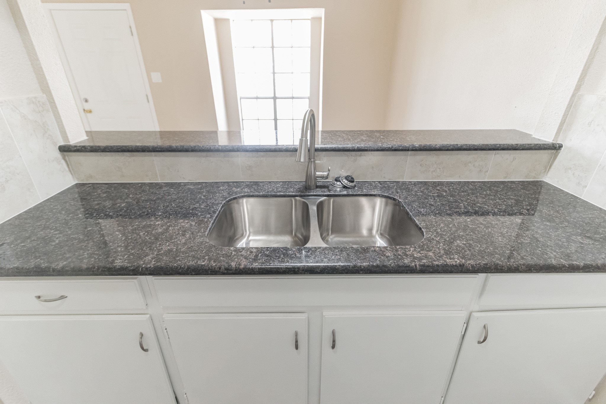 6815 Beachwood Street, Unit 1 Houston, TX 77021 - Photo 11 of 20 a close view of granite counter top a sink and dishwasher