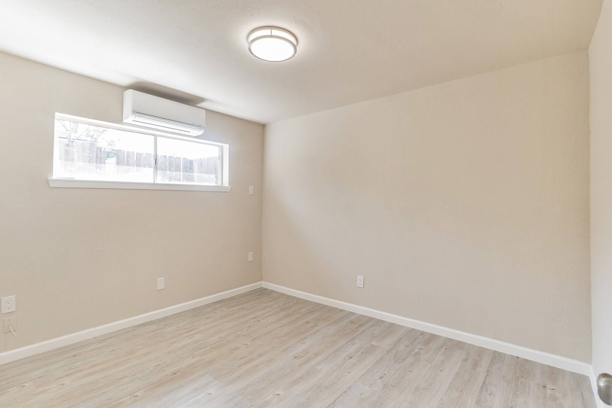 6815 Beachwood Street, Unit 1 Houston, TX 77021 - Photo 15 of 20 an empty room with wooden floor and windows