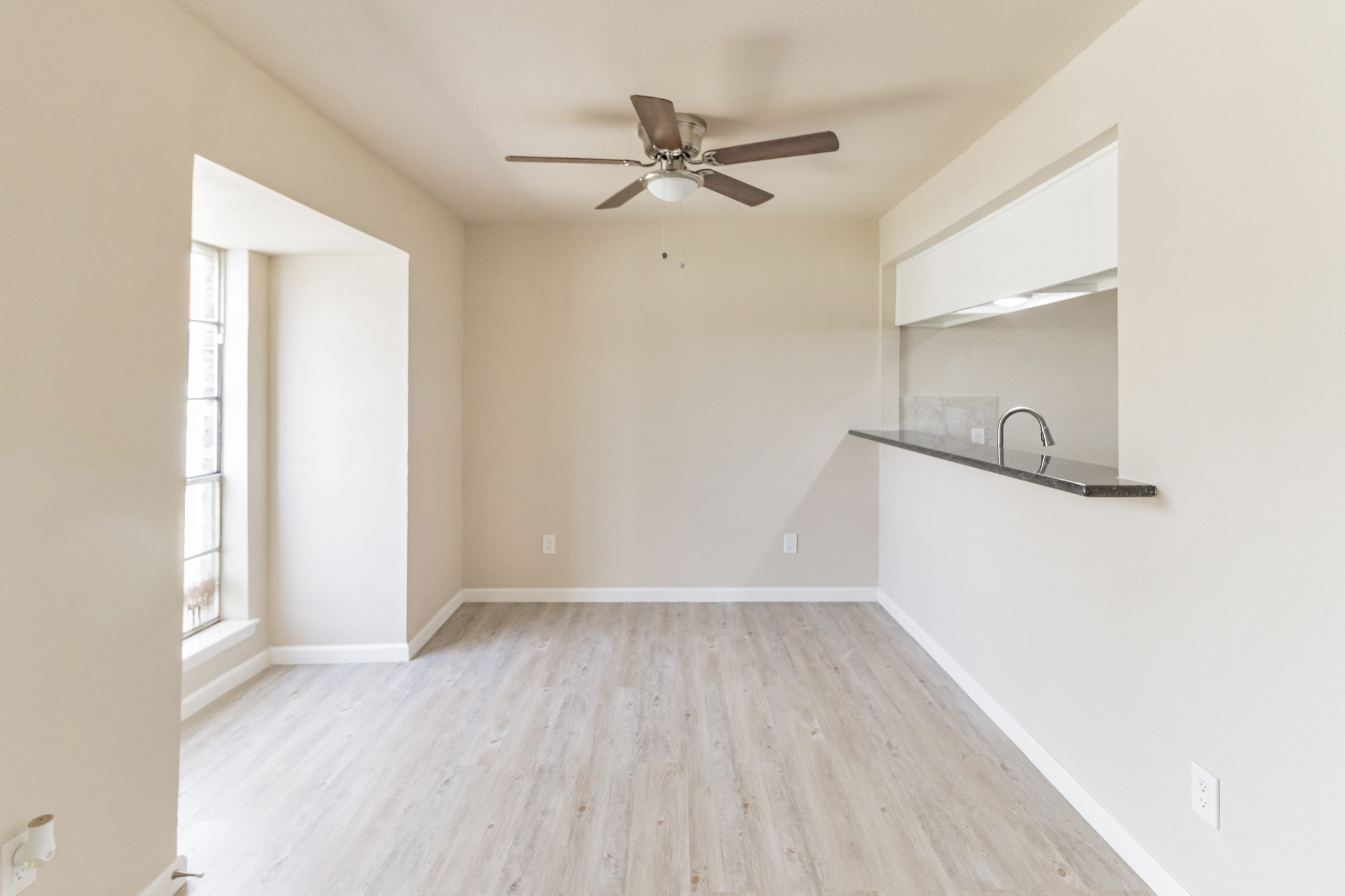 6815 Beachwood Street, Unit 1 Houston, TX 77021 - Photo 8 of 20 a view of a room with wooden floor and a ceiling fan