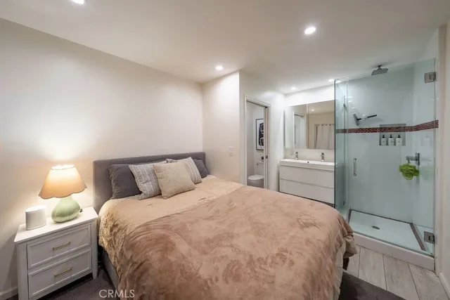 a bathroom with a shower a sink and a mirror