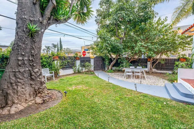 a view of backyard with outdoor seating and green space