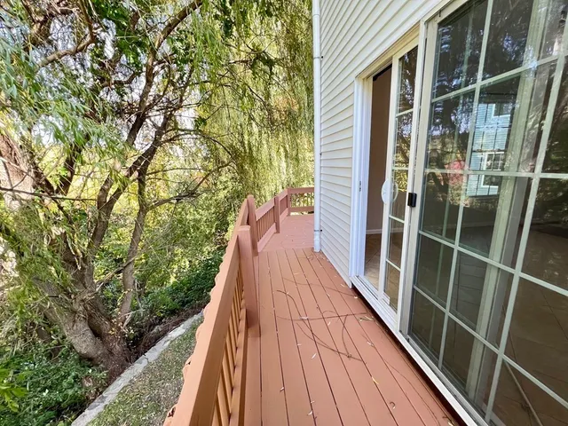 a view of balcony with wooden floor and fence and floor