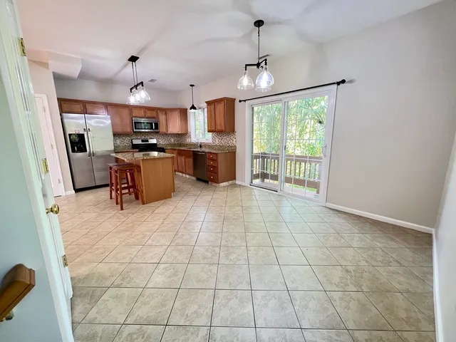 a view of kitchen with stainless steel appliances granite countertop a stove top oven a sink a counter top space cabinets and stainless steel appliances
