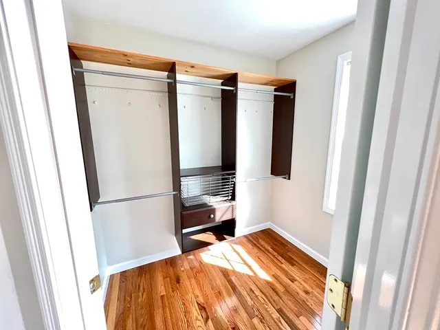 a bedroom with a bed and a refrigerator