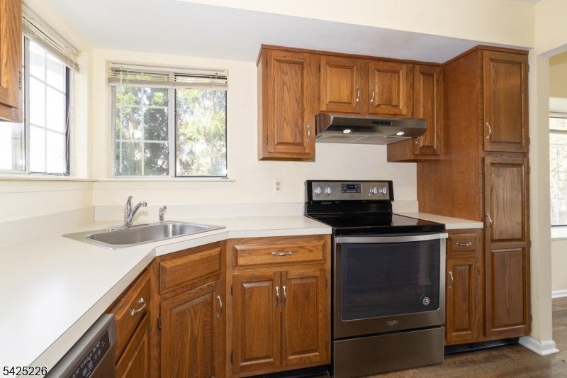 90 Mayfield Road, Unit 90 Bedminster, NJ 07921 - Photo 12 of 38 a kitchen with stainless steel appliances granite countertop a stove a sink and a microwave
