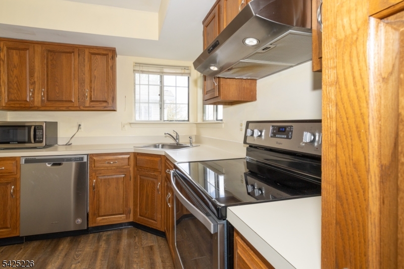 90 Mayfield Road, Unit 90 Bedminster, NJ 07921 - Photo 13 of 38 a kitchen with a stove microwave and cabinets