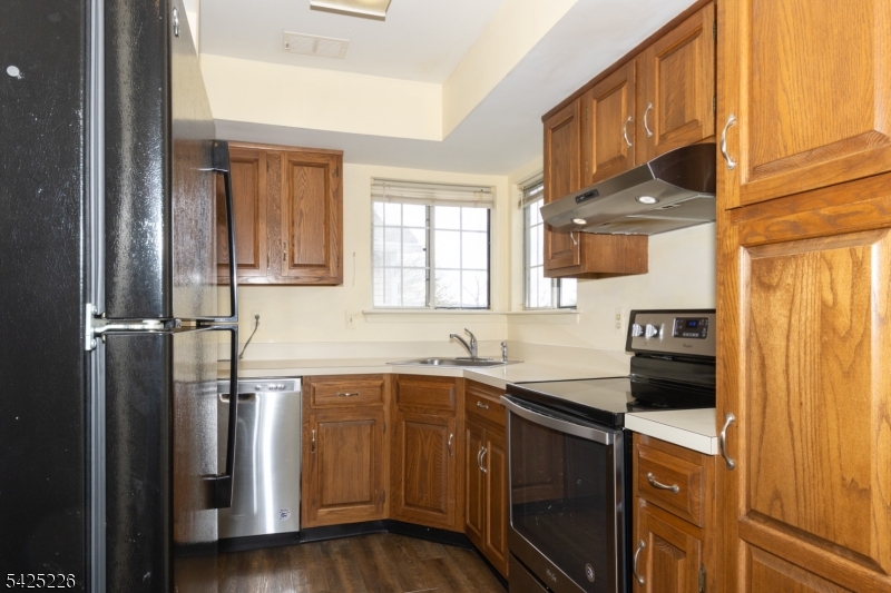 90 Mayfield Road, Unit 90 Bedminster, NJ 07921 - Photo 14 of 38 a kitchen with a sink stove and cabinets