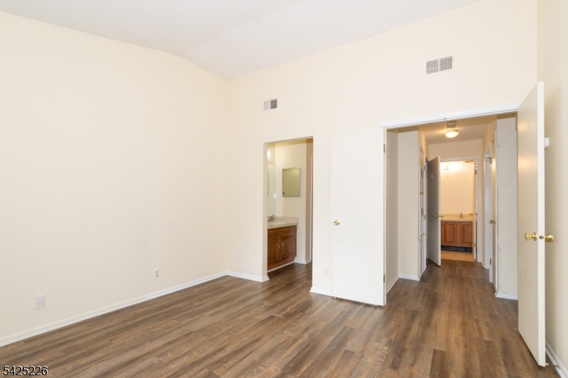 90 Mayfield Road, Unit 90 Bedminster, NJ 07921 - Photo 15 of 38 a view of a hallway with wooden floor