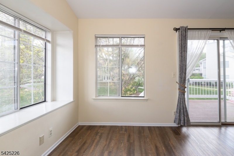 90 Mayfield Road, Unit 90 Bedminster, NJ 07921 - Photo 17 of 38 a view of an empty room with wooden floor and a window