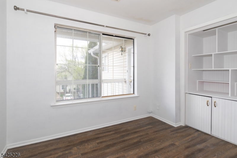 90 Mayfield Road, Unit 90 Bedminster, NJ 07921 - Photo 21 of 38 a view of an empty room with wooden floor and a window