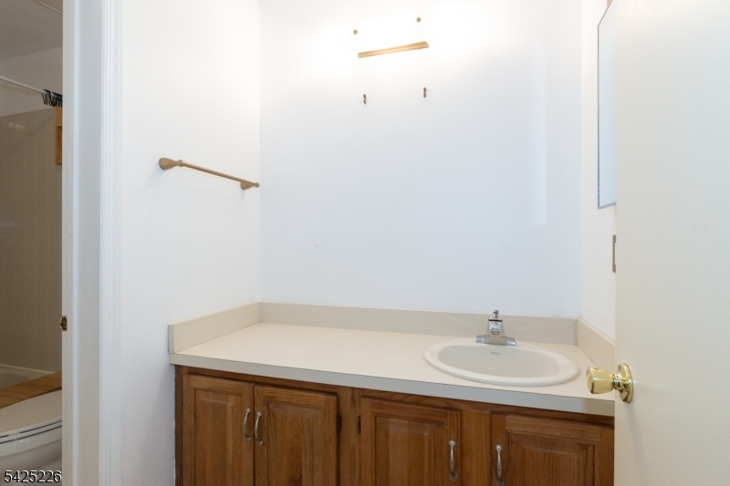 90 Mayfield Road, Unit 90 Bedminster, NJ 07921 - Photo 24 of 38 a bathroom with a sink and a mirror