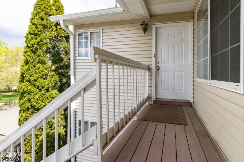 90 Mayfield Road, Unit 90 Bedminster, NJ 07921 - Photo 30 of 38 a view of balcony with wooden floor and fence