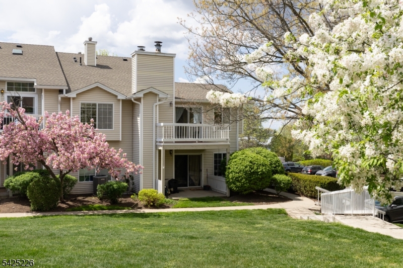 90 Mayfield Road, Unit 90 Bedminster, NJ 07921 - Photo 5 of 38 a front view of a house with a yard and garage