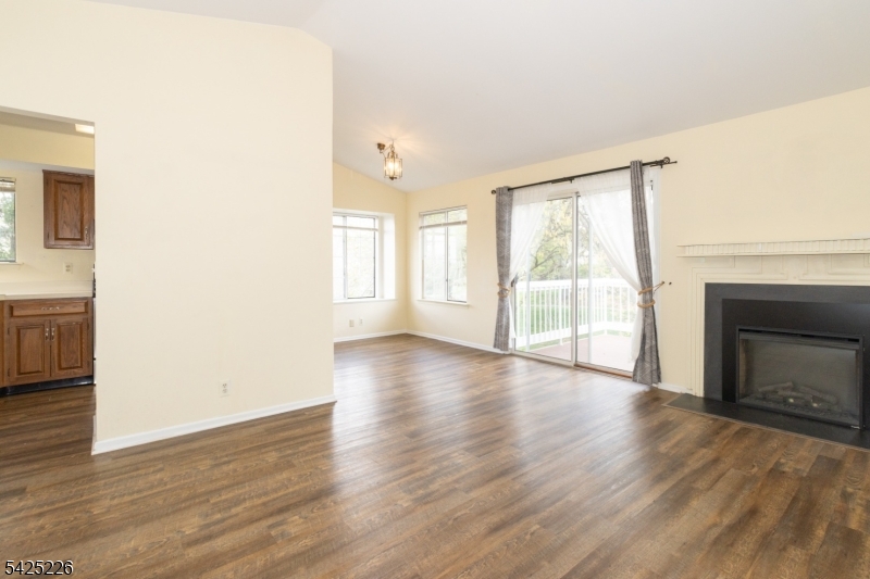 90 Mayfield Road, Unit 90 Bedminster, NJ 07921 - Photo 6 of 38 a view of an empty room with a window and wooden floor