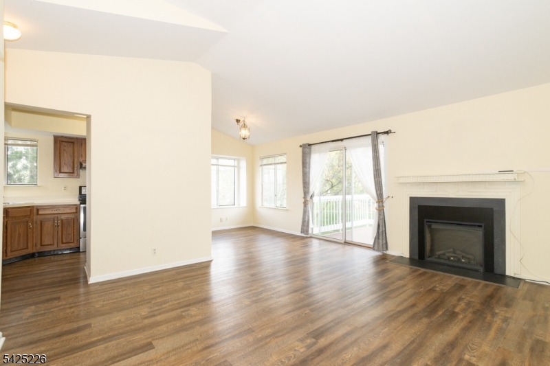 90 Mayfield Road, Unit 90 Bedminster, NJ 07921 - Photo 8 of 38 a view of an empty room with a fireplace and a window