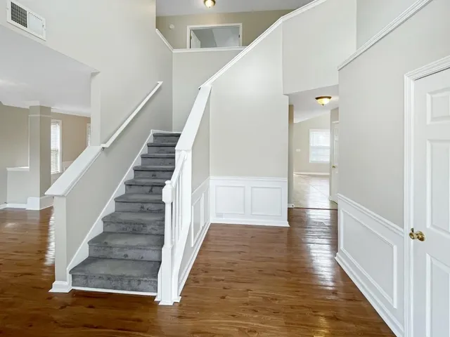 a view of entryway and hall with wooden floor