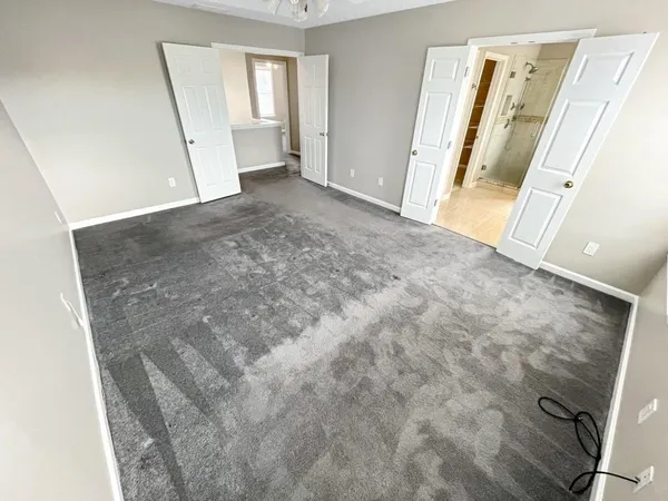 a spacious bathroom with a granite countertop tub sink and mirror
