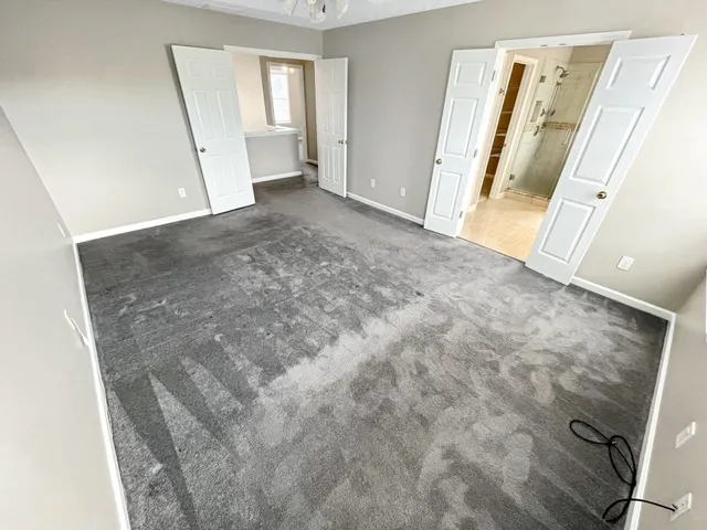 a spacious bathroom with a granite countertop tub sink and mirror