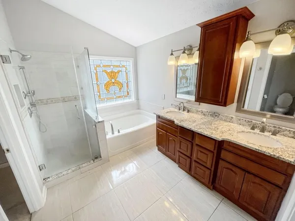 a bathroom with a tub sink and a mirror