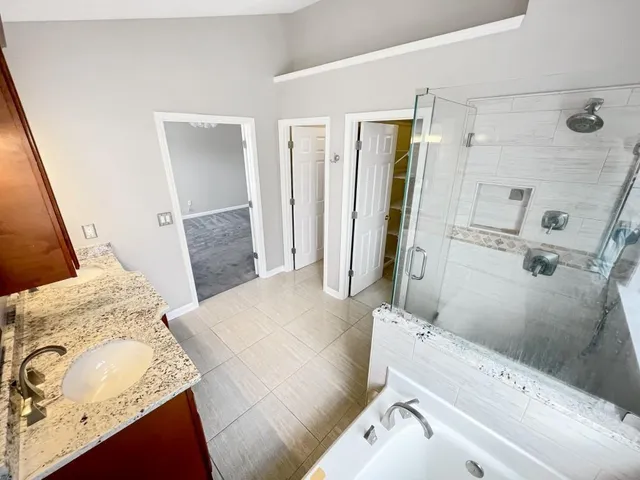 a bathroom with a tub and a shower