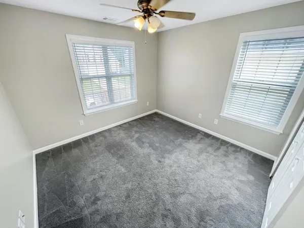 an empty room with a sink and a mirror