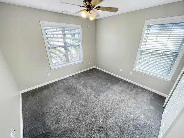 an empty room with a sink and a mirror