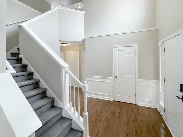 a view of entryway and hall with wooden floor
