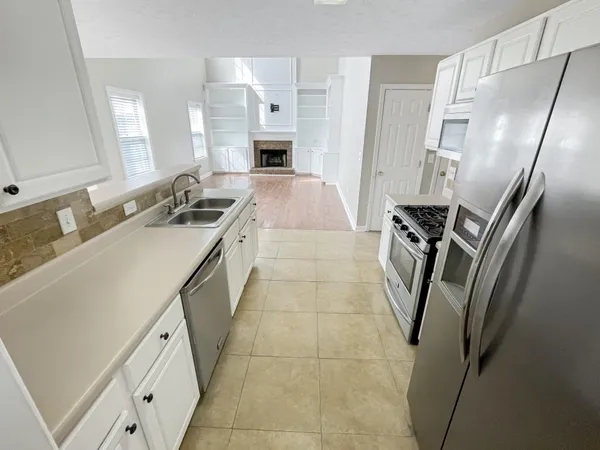 a kitchen with a sink appliances and cabinets