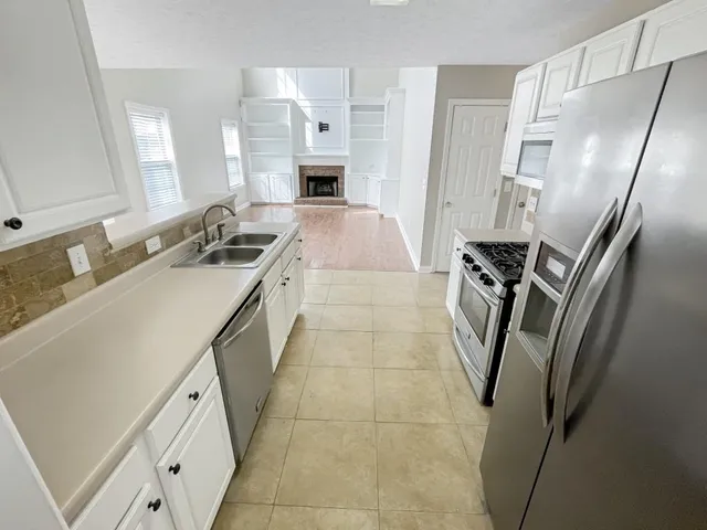a kitchen with a sink appliances and cabinets