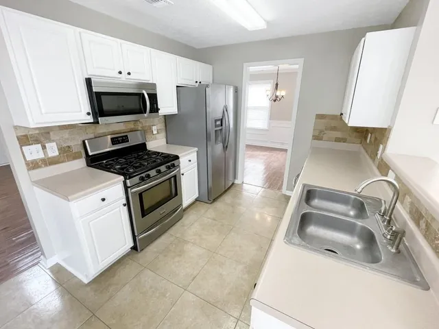 a kitchen with a sink stove and refrigerator