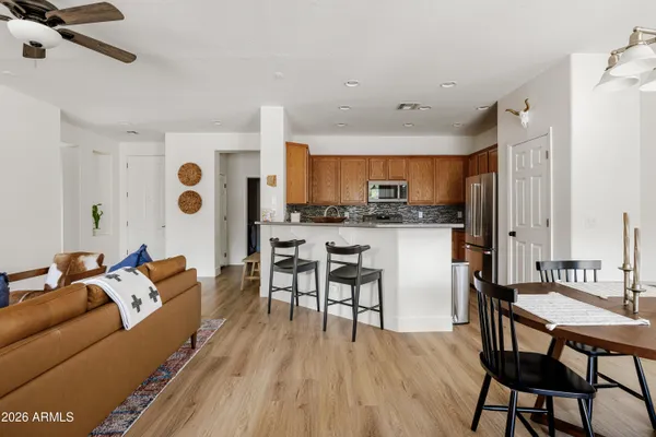 a living room with kitchen island furniture and a wooden floor