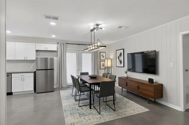 a kitchen with white cabinets and appliances
