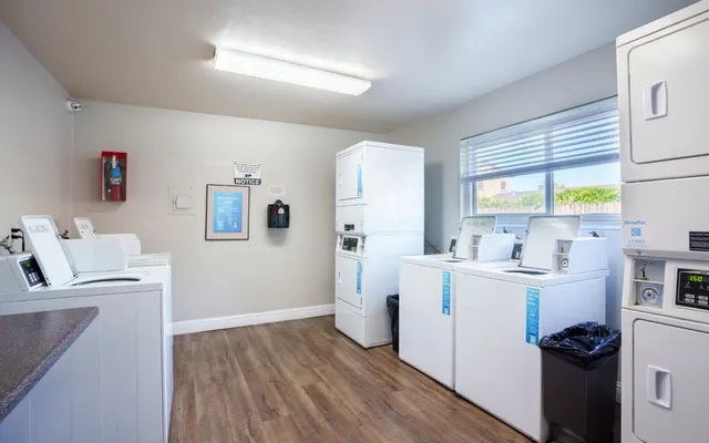 a view of a room with wooden floor and windows