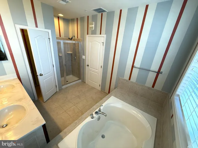 a bathroom with a tub and a sink