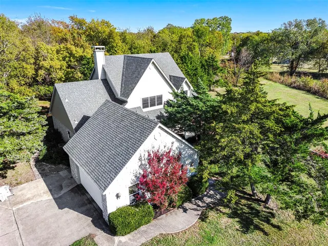 a view of a house with a yard and sitting area